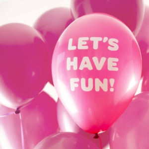 a pink balloon with the text let's have fun in a bold white font, surrounded by more pink balloons