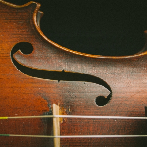A close up of the F hole in a violin