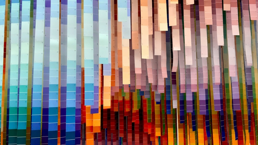 lots of colour swatch strips hang from the ceiling with every colour on display