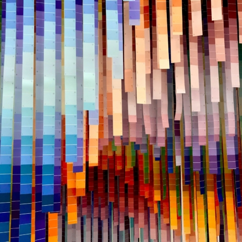 lots of colour swatch strips hang from the ceiling with every colour on display