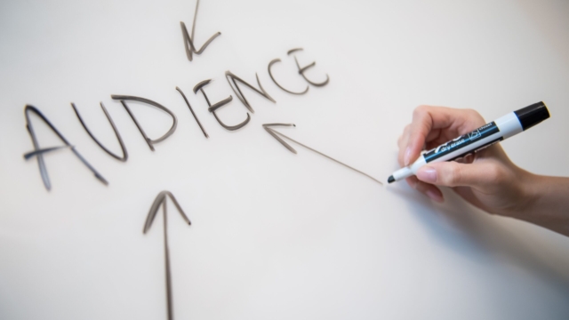 a whiteboard with the word AUDIENCE written in marker pen with arrows pointing at it