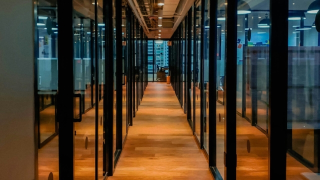 the view down a long corridoor with reflective doors on all sides